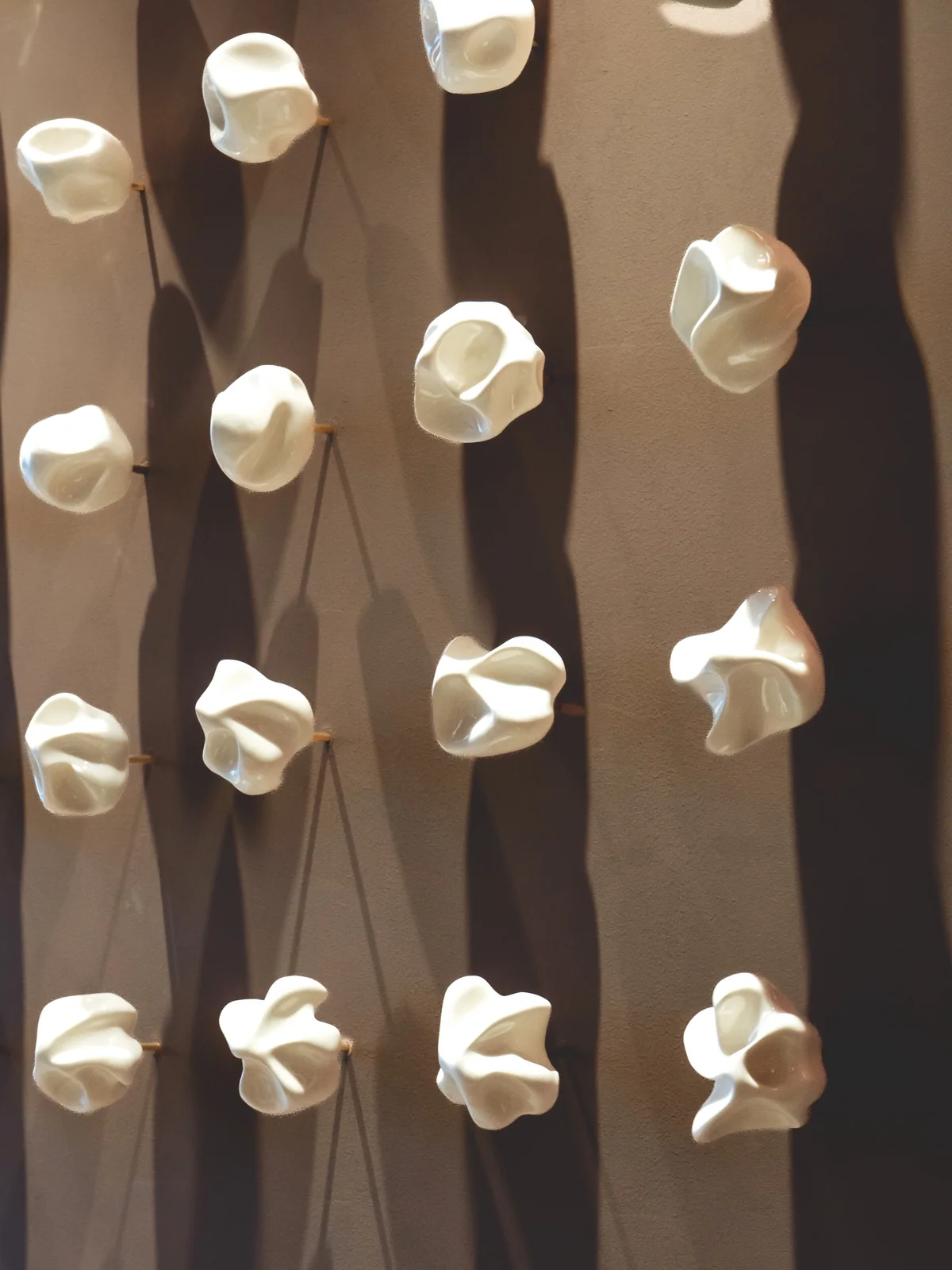 Close view of individually hand-formed porcelain elements and their shadows