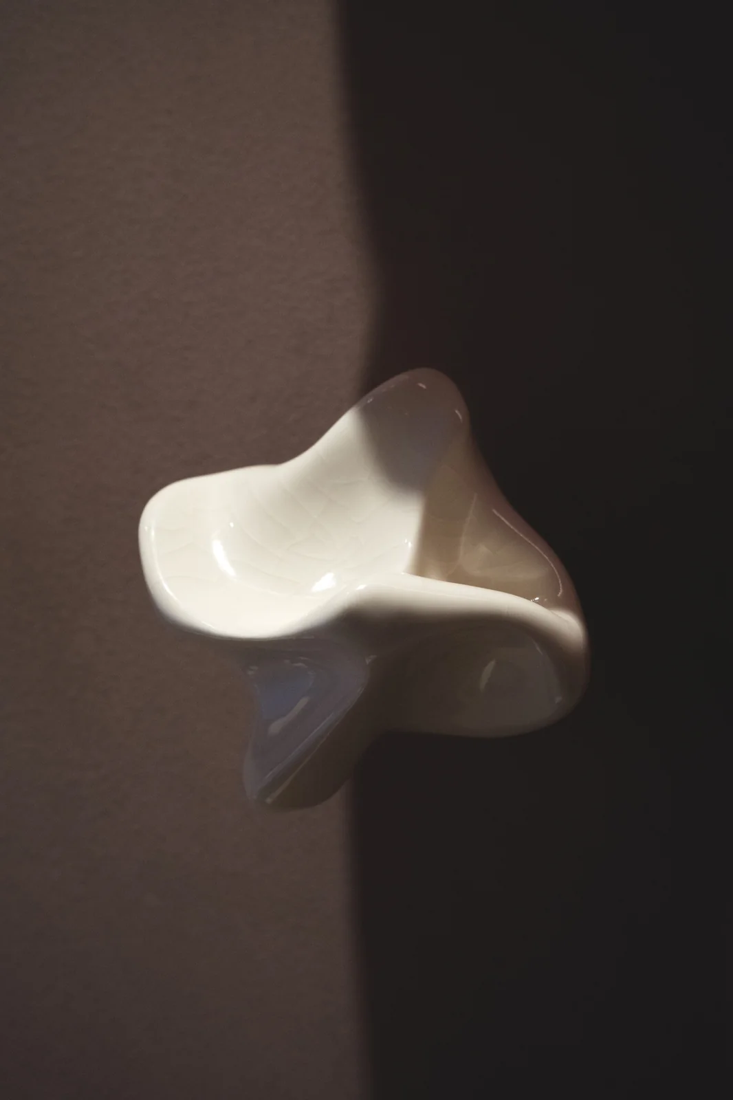 A single white porcelain element mounted on the wall