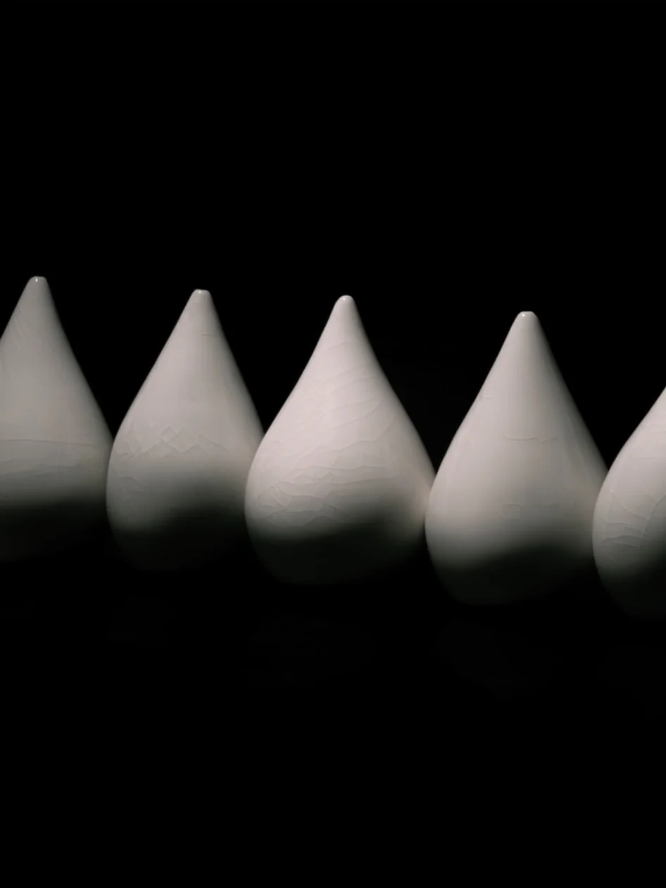 A sequence of white pointed forms against a black background