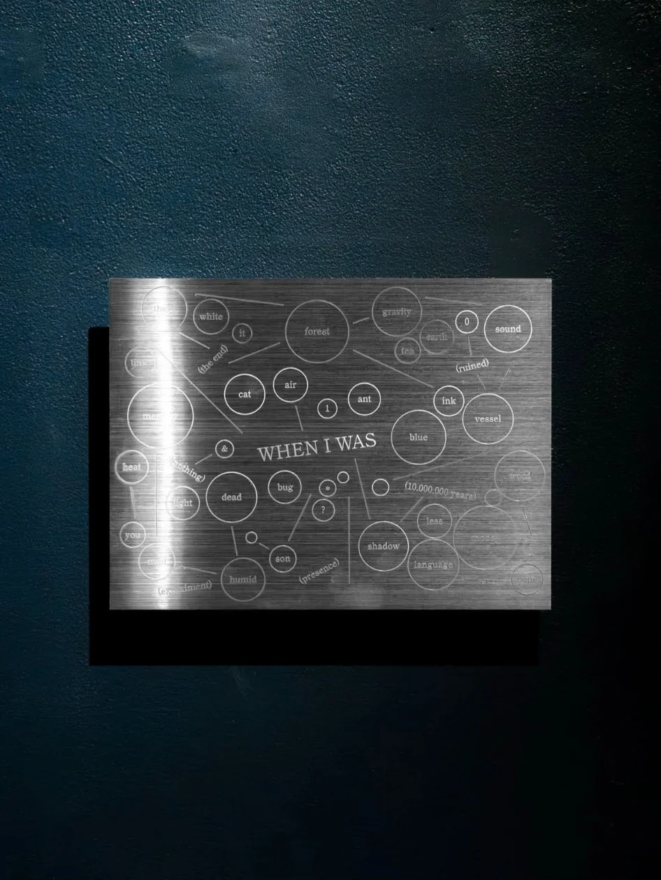 An engraved metal wall work with words and circles