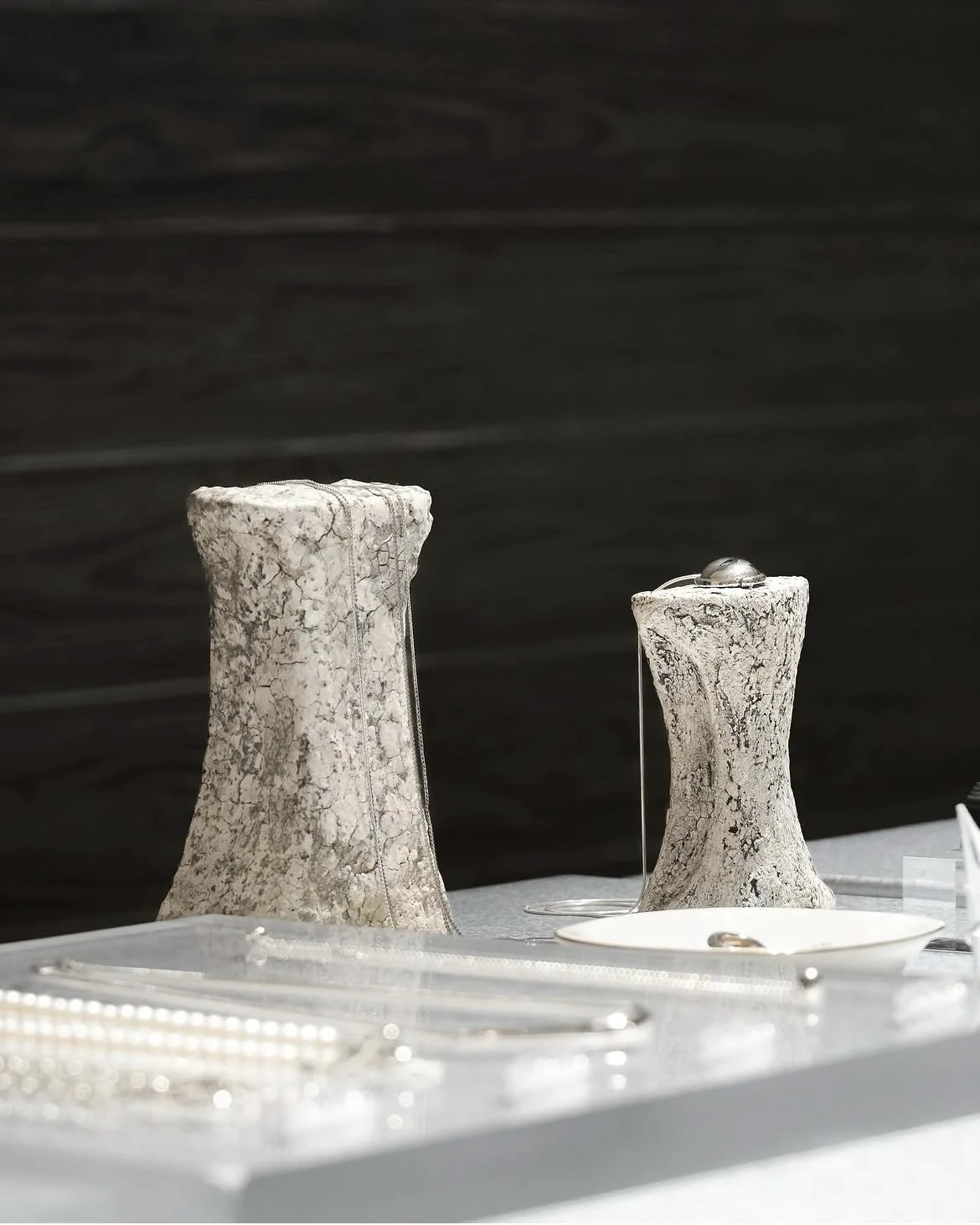 Two textured ceramic display stands used for jewelry