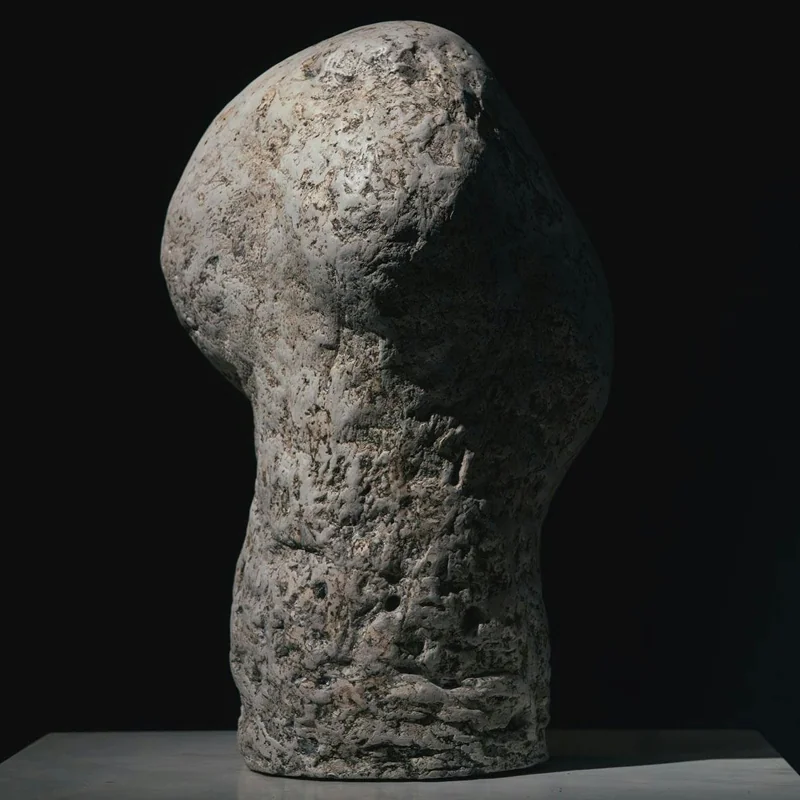 An upright sculptural form with a textured surface.
