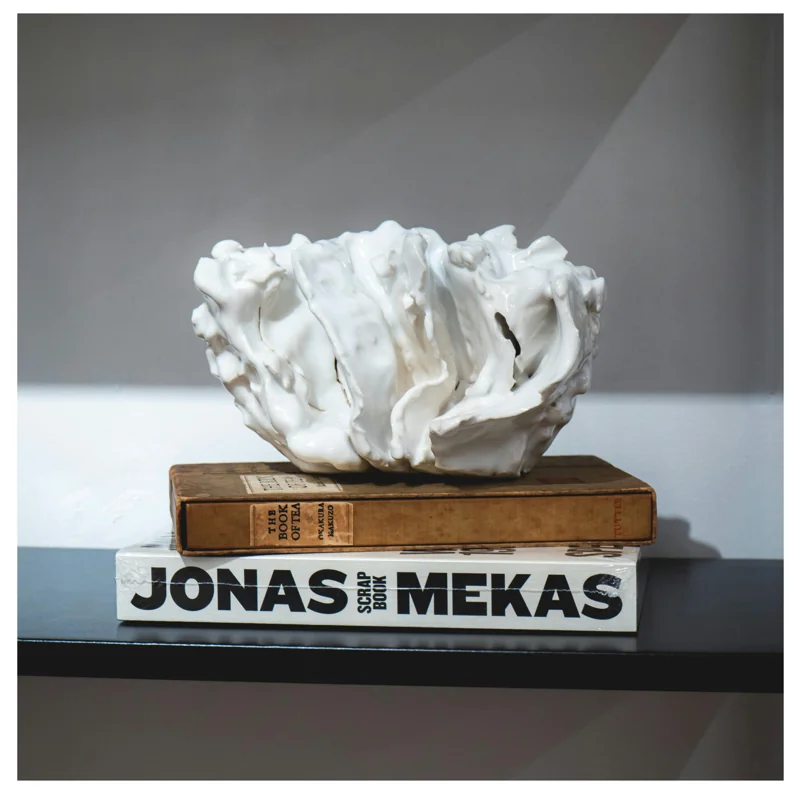 A porcelain form with a folded, irregular surface.