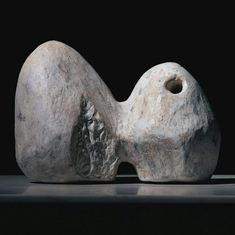 Two connected volumes, one pierced by a small opening.
