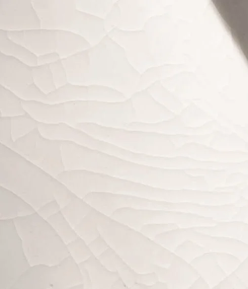 A pale ceramic surface articulated by fine fissures