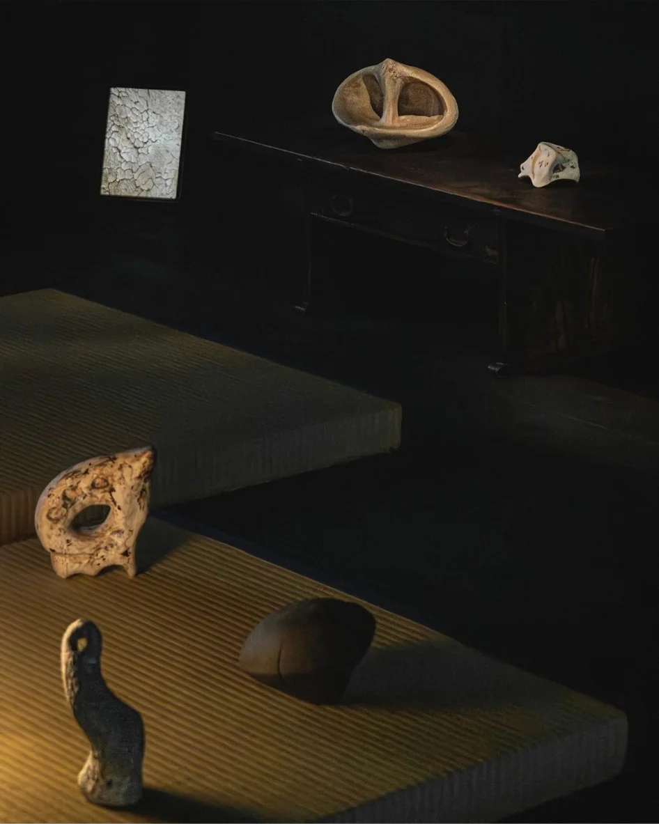 Ceramic objects displayed on tatami and dark wooden furniture